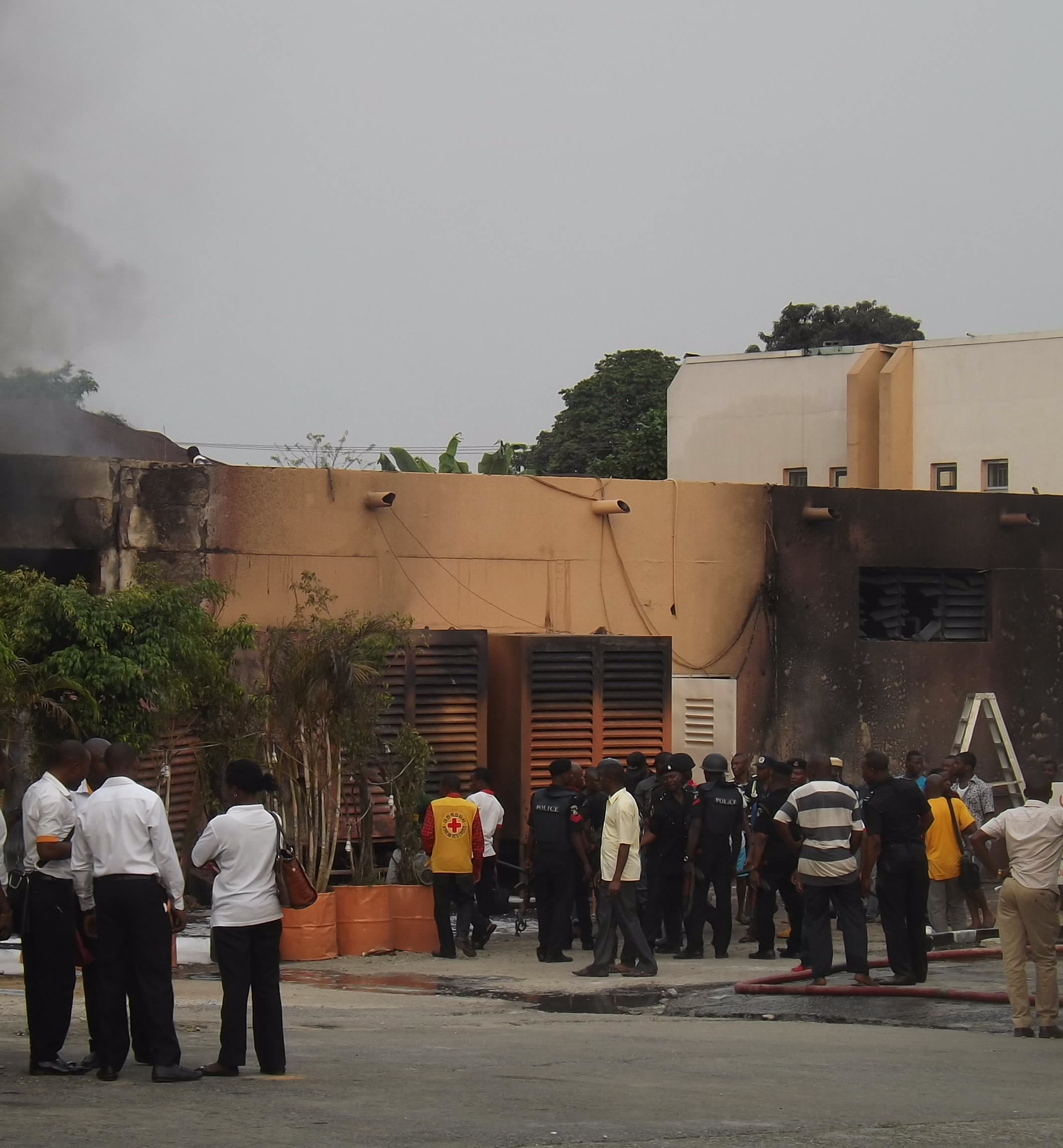 Staff and security men at the scene of the fire
